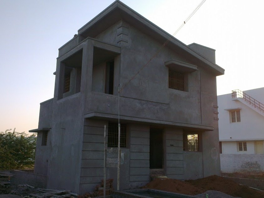 The same house plastered and grey, scaffolding down, before painting — in Pannimadai, Coimbatore