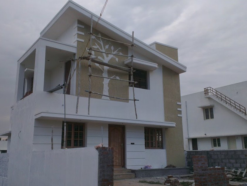 The compound wall built and the site cleared around the finished house — in Pannimadai, Coimbatore